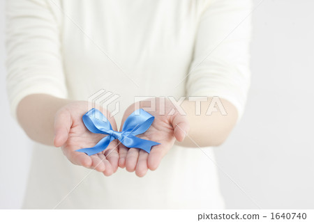 Female hands and blue ribbon Female hands and blue ribbon 1640740