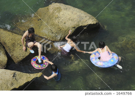 Four people climbing rocks Four people climbing rocks 1649766