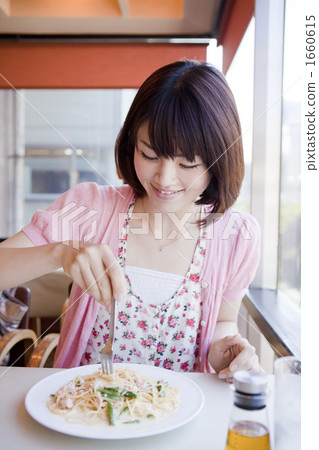 A woman eating pasta at a cafe A woman eating pasta at a cafe 1660615
