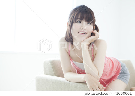Young woman relaxing on a sofa 1668061
