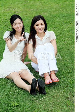 Sisters sitting on the lawn 1671536