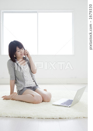 A woman who calls in front of a personal computer 1679330