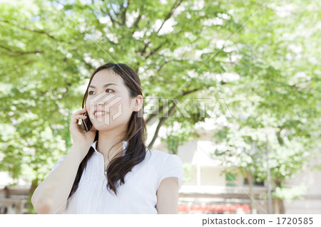 A young woman making a phone call outdoors 1720585