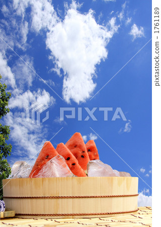 Watermelon longitudinal position cold with blue sky, clouds and ice 1761189