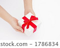 A picture of a woman's hand giving a gift A picture of a woman's hand giving a gift 1786834