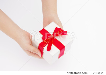 A picture of a woman's hand giving a gift A picture of a woman's hand giving a gift 1786834