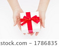 A picture of a woman's hand giving a gift A picture of a woman's hand giving a gift 1786835