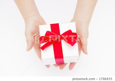 A picture of a woman's hand giving a gift 1786835