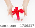 A picture of a woman's hand giving a gift A picture of a woman's hand giving a gift 1786837