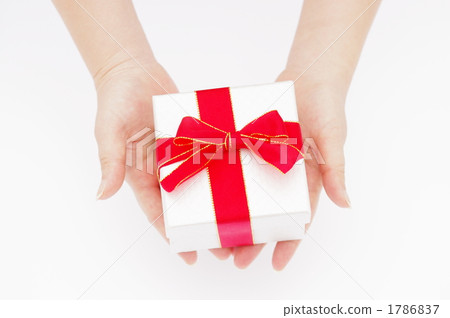 A picture of a woman's hand giving a gift 1786837