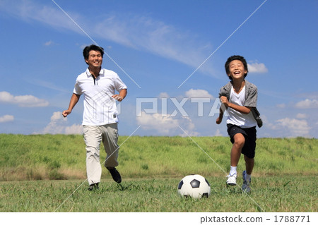 Parents playing with soccer ball 1788771