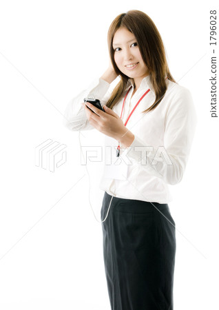 A woman listening to music on a smartphone 1796028