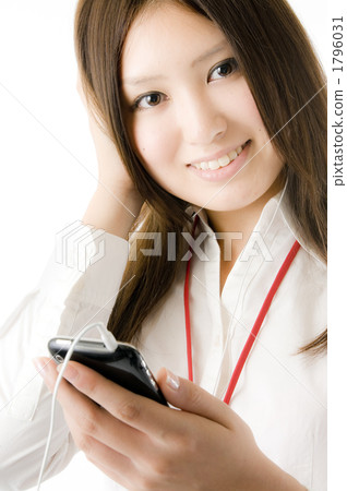 A woman listening to music on a smartphone 1796031