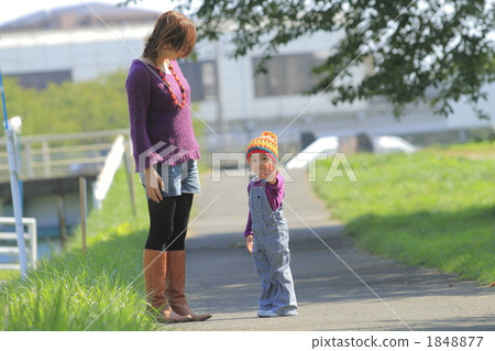 A girl walking along Mama and the bank A girl walking along Mama and the bank 1848877
