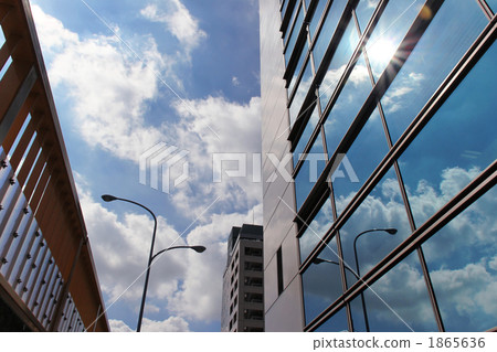 During the rainy season, the sun and the blue sky reflected on the walls of the building 1865636