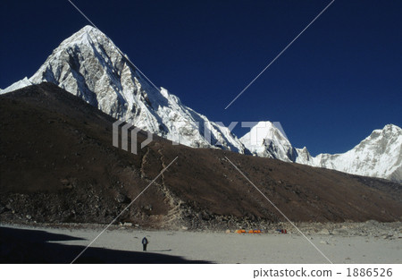 Overlooking a hill of snow pumori (7161 m) and rocky Kalapatar (5545 m) from Gorakshep 1886526