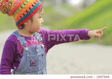 A girl walking along the levee 1887848