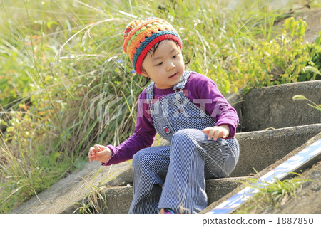 Girl sitting on the staircase of the bank 1887850