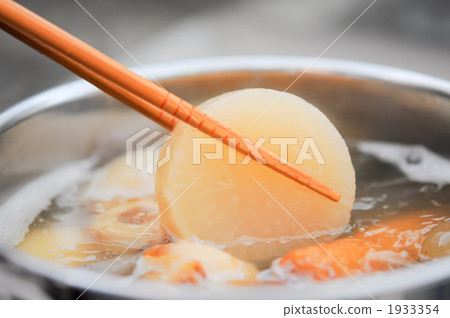 Close-up of picking up daikon radish in oden with chopsticks Close-up of picking up daikon radish in oden with chopsticks 1933354