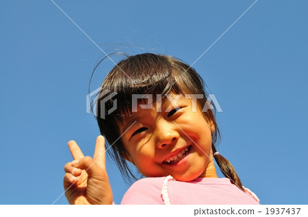 A girl deciding V sign in blue sky A girl deciding V sign in blue sky 1937437