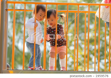 1 year old girls playing on the slide 1959576