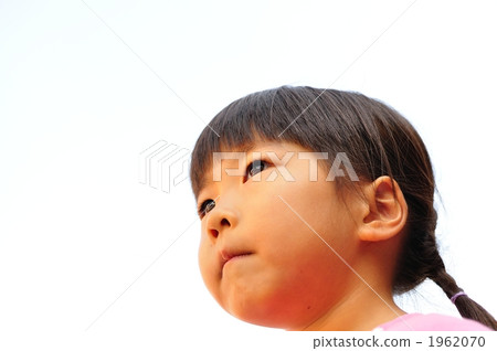 A girl looking up with a serious look 1962070