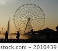 Ferris wheel and silhouette at dusk 2010439