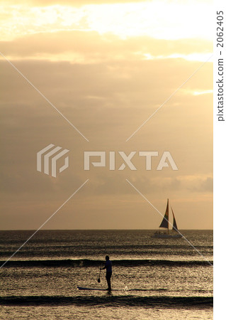 Yacht and paddle surfing at dusk 2062405