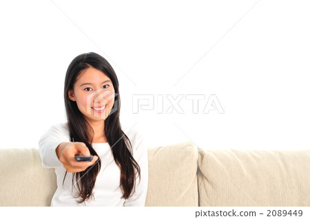 A woman who operates a TV remote control A woman who operates a TV remote control 2089449