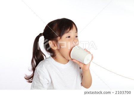 A girl playing with a thread phone 2103700