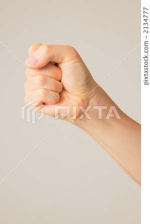 A man's hand clenching into a fist A man's hand clenching into a fist 2134777