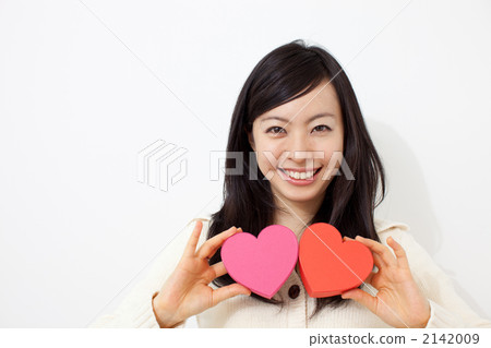 有一顆心的婦女在兩隻手上 2142009