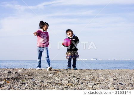 Sisters playing on the beach Sisters playing on the beach 2163144
