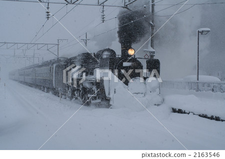 Steam locomotive running in heavy snow Ban overpass line 2163546