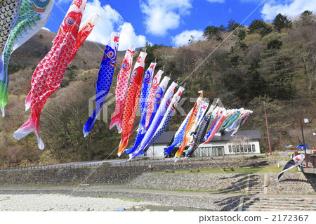 Carp streamers passing a river 2172367