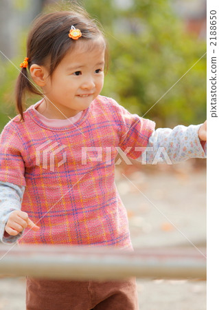 A 2 year old girl playing in the park A 2 year old girl playing in the park 2188650