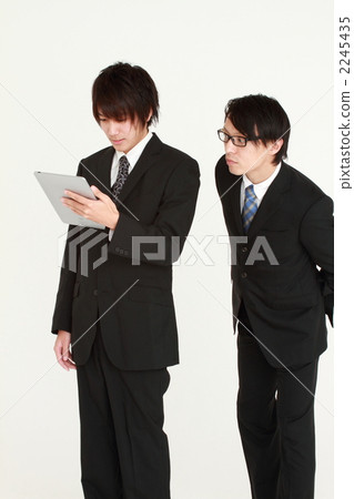 A businessman looking at the iPad A businessman looking at the iPad 2245435