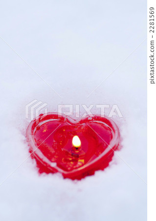 Heart shaped candle in the snow 2281569