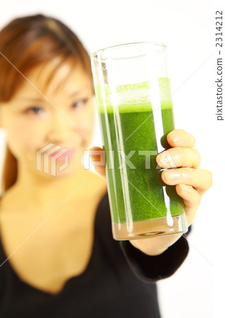 A woman drinking green juice A woman drinking green juice 2314212