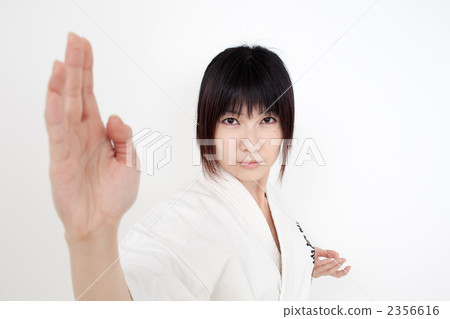 A woman practicing karate A woman practicing karate 2356616