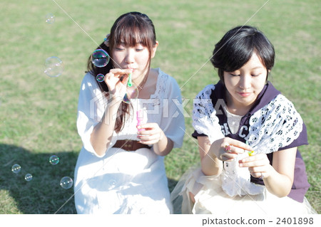 Two young women blowing soap bubbles 2401898