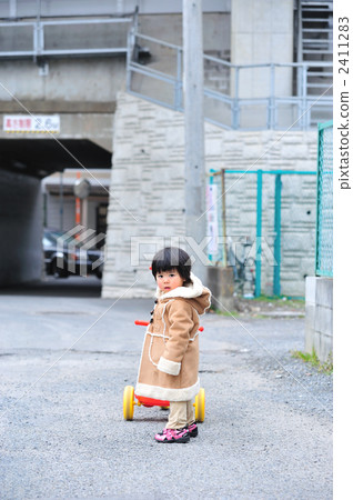 Tricycle and 2 year old child Tricycle and 2 year old child 2411283