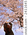 A woman shooting a cherry tree 2411645