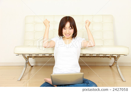A woman using a personal computer at home 2427058
