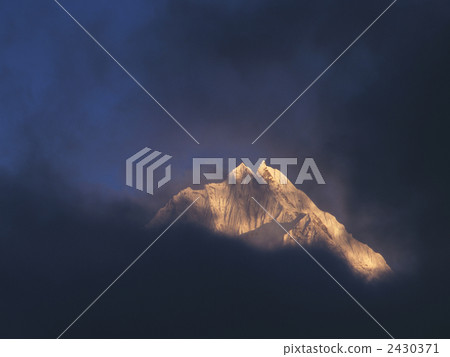 At sunset glow of Tamseluk (6623 m) floating in fog Nepal at Kumjung 2430371