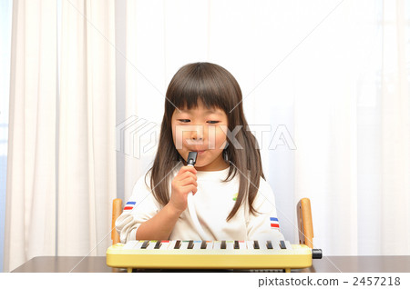 A girl playing a pianica 2457218
