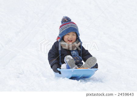 A 4 year old boy playing in the snow 2459643