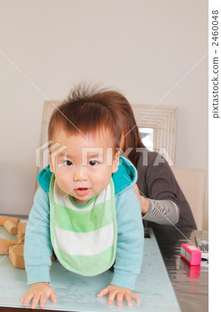 A 1 year old boy playing with us 2460048