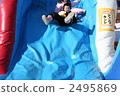 Elementary school students playing on the slide 2495869