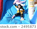 Elementary school students playing on the slide 2495873